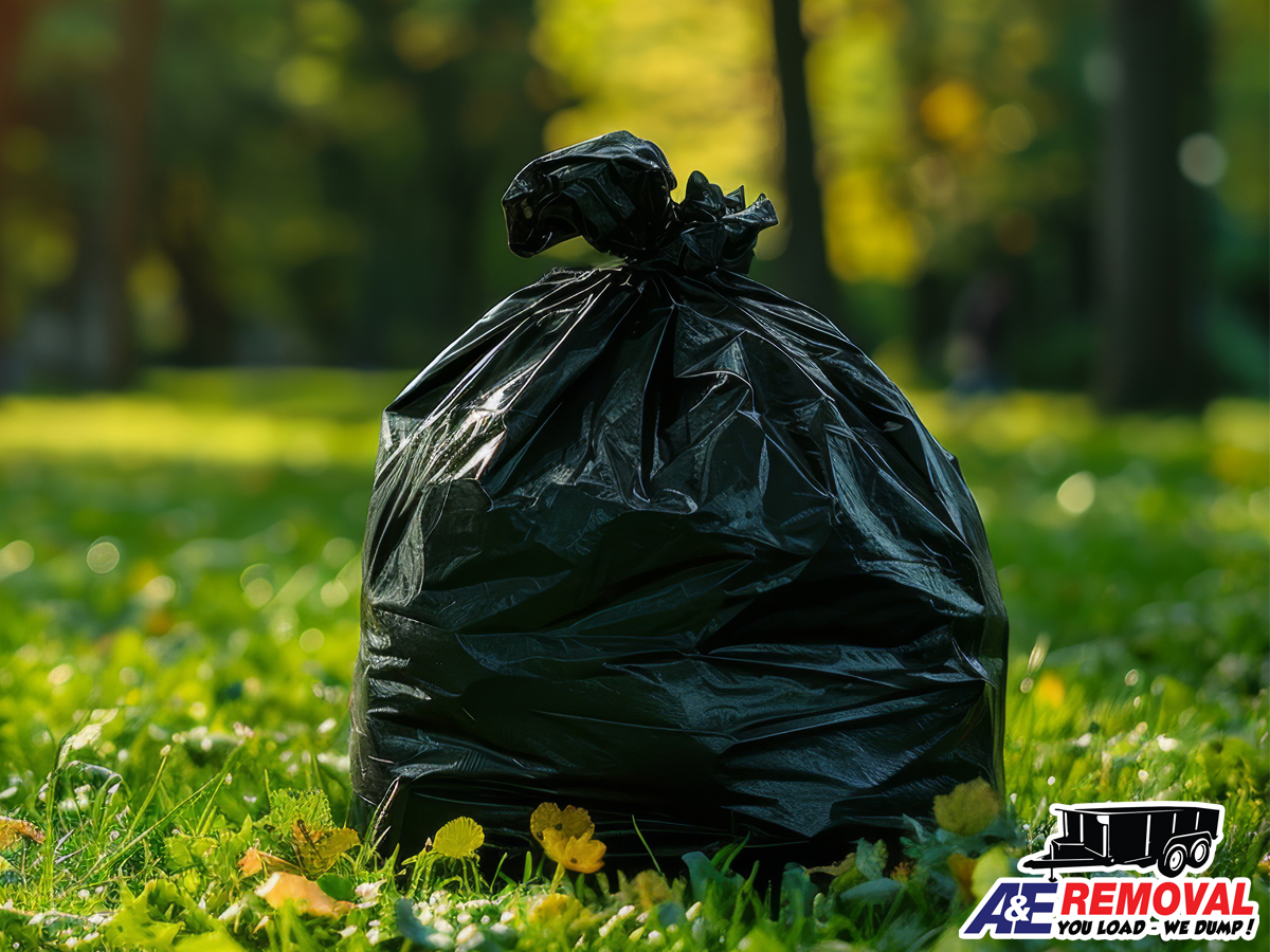 Large blakc plastic bag on a freshly mowed lawn